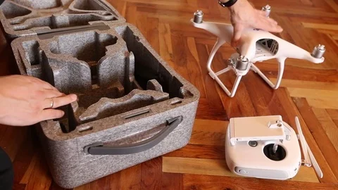 Taking a DJI Phantom 4 drone out of the case Vídeos de archivo 71007292