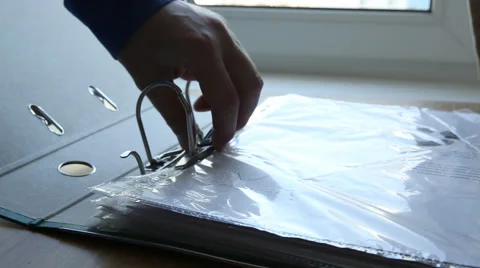 Taking a document from a holder Stock Footage 50362961