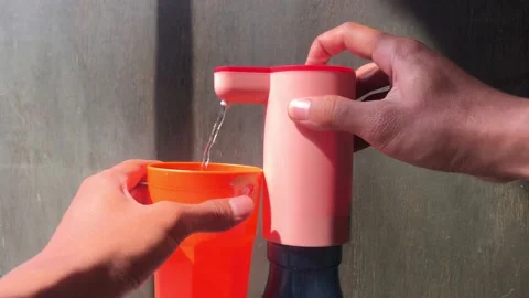 Taking drinking water into a cup Stock Footage 205346330