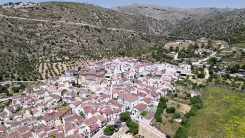Taking a drone shot, one could spot a charming Village surrounded by lush Hills Stock Footage 287179048