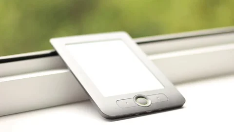 Taking the electronic book from the windowsill and putting it back 動画素材 79786181