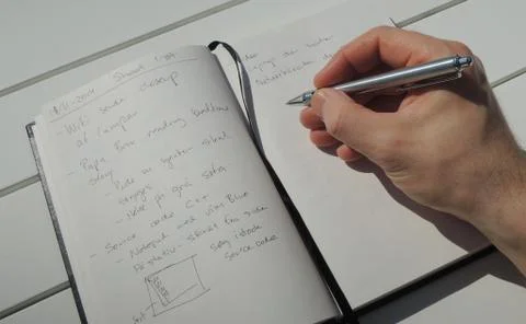 Taking a few notes in my personal idea journal Stock Photos