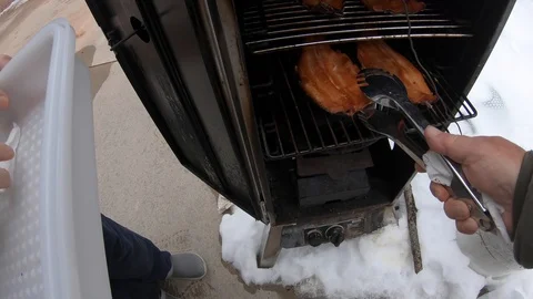 Taking Finished Smoked Trout or Salmon Out of the Smoker Stock Footage 127304103