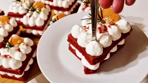 Taking a fork bite of red velvet cake with cream cheese frosting on white plate Stock Footage 327258941