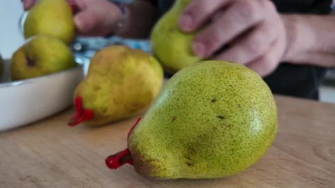 Taking fresh Comice pear from serving bowl Video stock 347011886