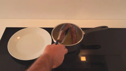 Taking fresh cooked Sausages from boiling water Stock Footage 145648713