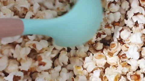Taking fresh popcorn out with laddle. Stock Footage 159442341
