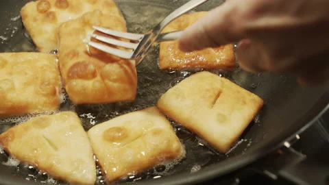 Taking fried dough from cast-iron pan 4K video Stock Footage 174690384