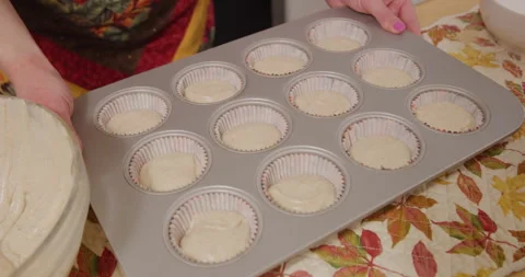 Taking full unbaked cupcake tray from counter Stock Footage 249352171