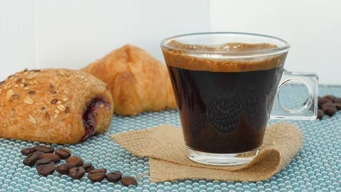 Taking glass coffee cup on breakfast table, croissants near.  traditional  Stock Footage 117133971