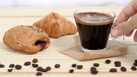 Taking glass coffee cup on breakfast table, croissants near.  traditional  Stock Footage 117134500