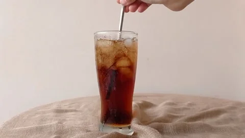 Taking a glass of cold cola from a table Stock Footage 146251322