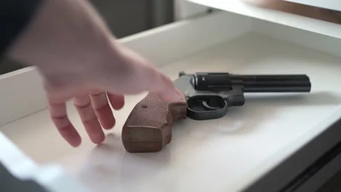 Taking a Gun From a Drawer Closeup Shot Revolver Pistol 库存影片 167379449