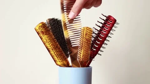 Taking hairbrush from a can and putting it back Stock Footage