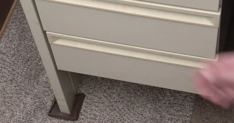 Taking Hand Gun from Drawer - Racking or Cocking Gun - Office 库存影片 127513051