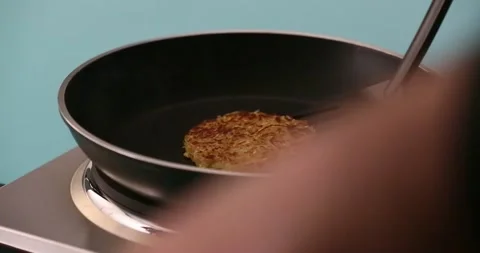 Taking the hash browns out of the pan 2 Video stock 132152038
