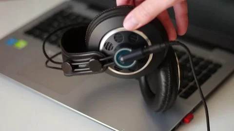 Taking headphones from a notebook Stock Footage 77026582