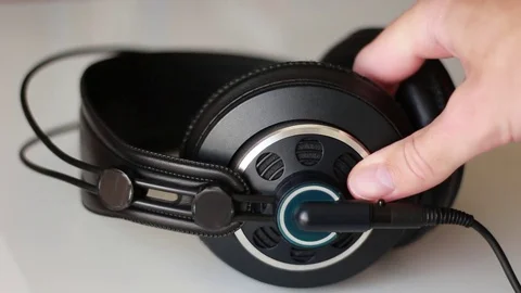 Taking headphones from white surface Vídeo Stock 76999282