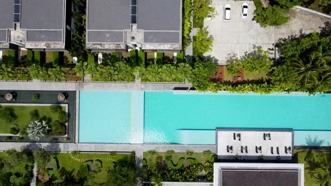 Taking off high above the swimming pool in a hotel in the tropics Stock Footage 171689895