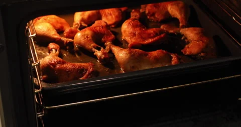 Taking hot fried chicken legs out of the oven, male hands Stock Footage 243211191