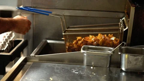 Taking Hot Fried Potatoes From Hot Oil in Super Slow Motion Stock Footage 125338925