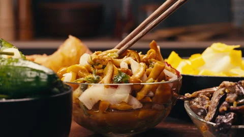 Taking a little bit of fermented yellow honeydew mushrooms with onion by Stock Footage 275100498