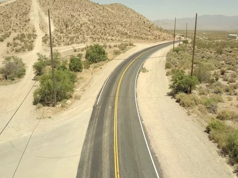 Taking off the lonely road in desert Stock Footage 77656355