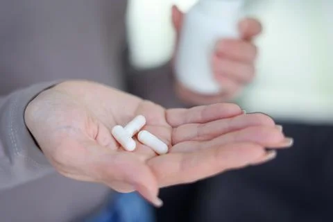 Taking Medication An InDepth Close Up View of Various Pills and Water for Foto stock