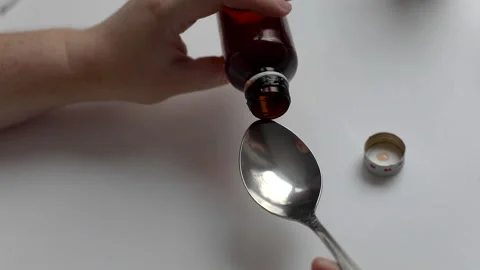 Taking medication, pouring the texture into a spoon close-up, baby antipyretic Stock Footage 147070267