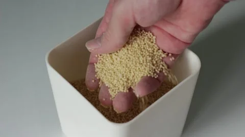 Taking millet with hand from a container 動画素材 66755624