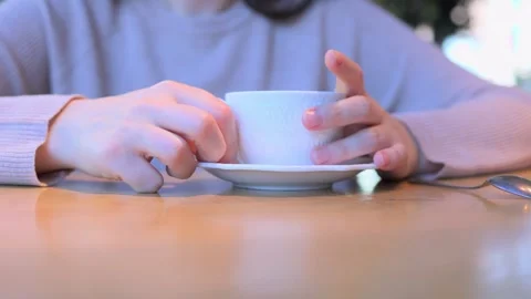 Taking a moment to reflect while sipping coffee from a cozy spot at a wooden Video stock 312440644