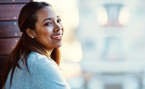 Taking my break on the balcony. Portrait of an attractive young businesswoman Stock Photos