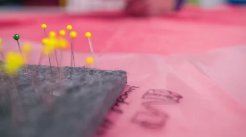 Taking needle and pinning together plastic and textile Stock Footage 41012912