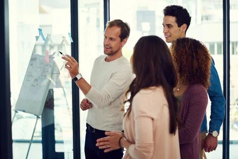 Taking note of where their creative direction is heading. a group of young Stock Photos