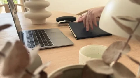Taking notebook for planning in minimalist home office workspace Stock Footage 334042265
