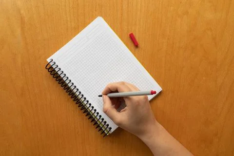 Taking notes in blank paper white notebook. graph, grid, black squared, woman Stock Photos