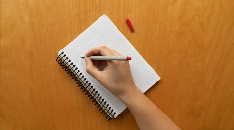 Taking notes in blank paper white notebook. graph, grid, black squared, woman Stock Photos