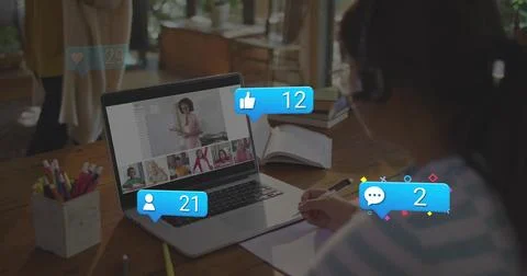 Taking notes child in striped top headset joining class from home with laptop 스톡 사진