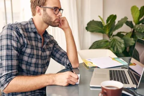 Taking notes from the computer screen 스톡 사진