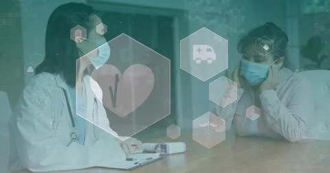 Taking notes doctor in lab coat consulting patient at clinic table with Stock Photos