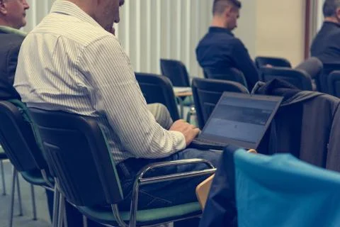 Taking notes on a laptop at conference. Stock Photos