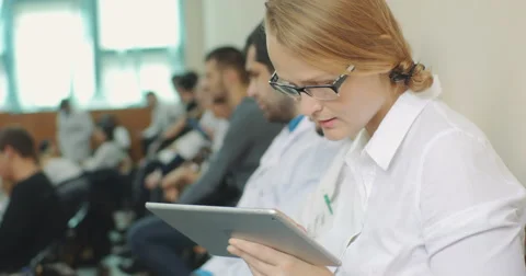 Taking notes on pad during medical conference Stock Footage 52390299