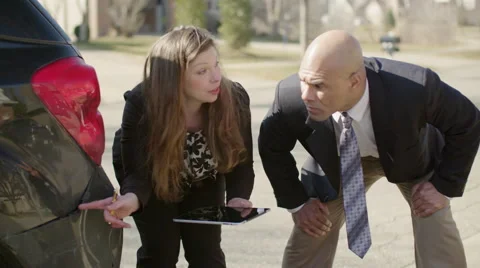 Taking notes on tablet while inspecting car damage 4K Stock Footage 48982496