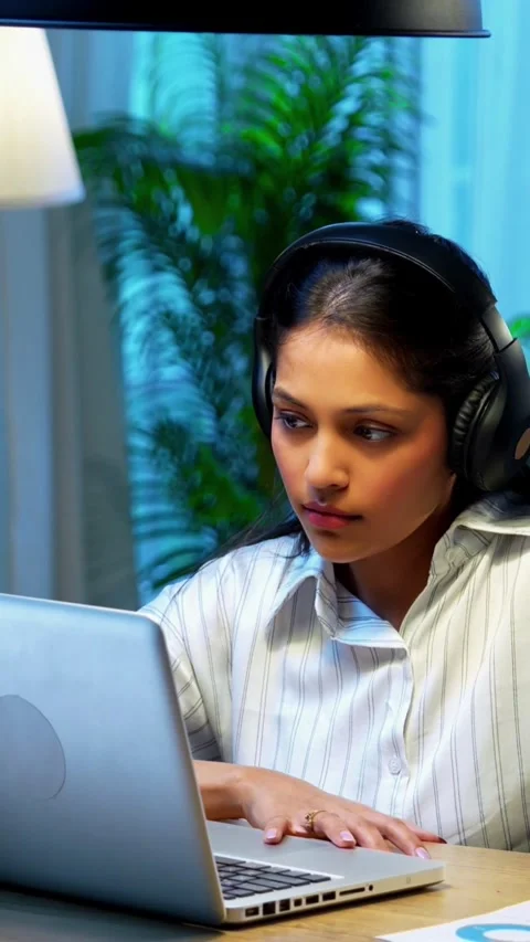 Taking notes from video call, Indian businesswoman uses headphone Stock Footage 342572791