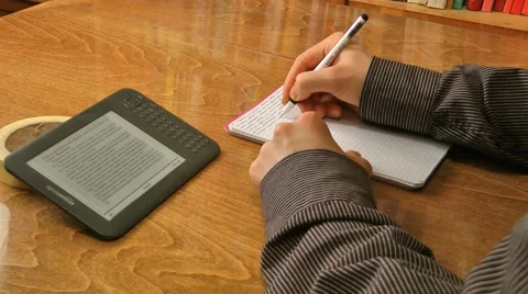 Taking notes while reading an e-book Stock Footage 47650602