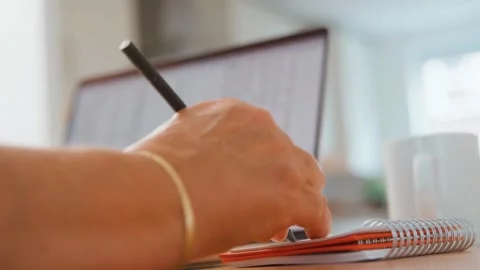 Taking Notes While Working in a Home Office Stock Footage 299682661