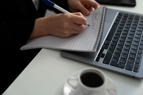 Taking notes while working on laptop, efficient workflow Stock Photos