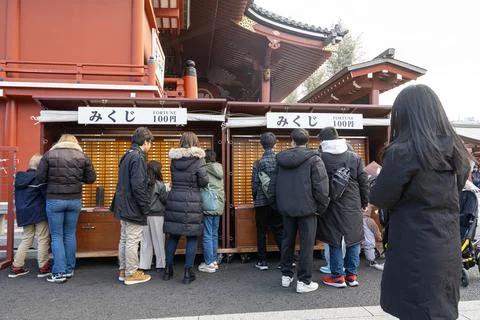 Taking the Omikuji, the slips that predict the future at the Senso ji templ.. Stock Photos