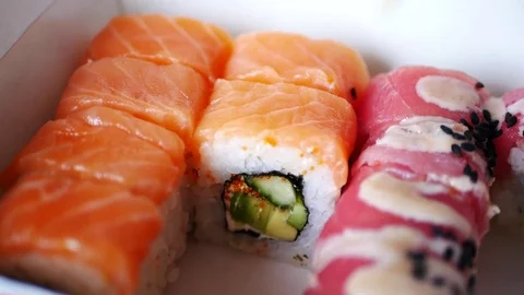 Taking one sushi roll from delivery box. Stock Footage 70674350