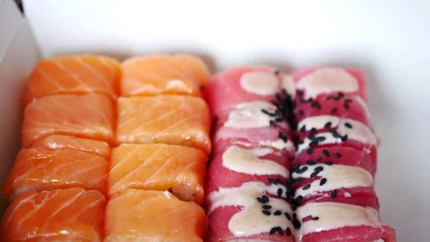 Taking one sushi roll from delivery box. Stock Footage 70675355